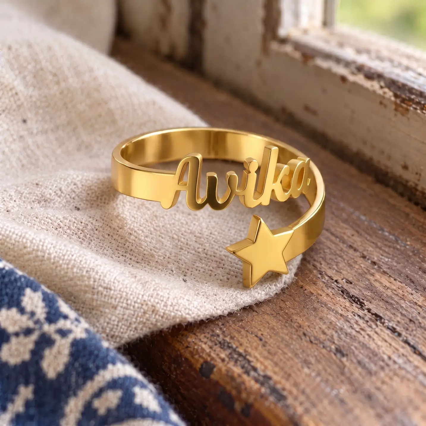 Personalized Star Name Ring – Image 3 Personalized Star Name Ring displayed on beige linen beside a wooden window