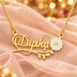 Flower and Leaf Name Necklace on peach fabric