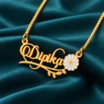 Flower and Leaf Name Necklace on dark green fabric