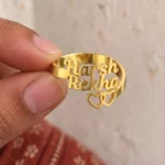 Two Hearts Personalized Love Ring held between fingers to show the personalized design