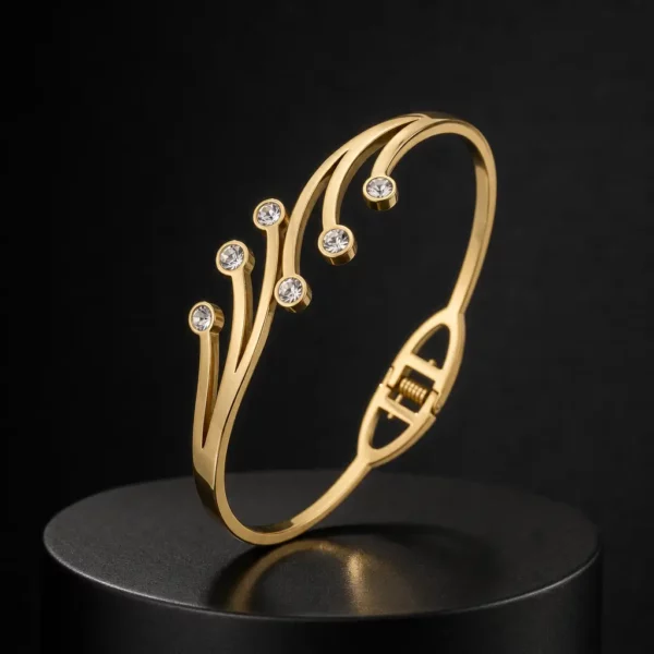 Golden Sparkle Bracelet with 6 Stones on a black display stand