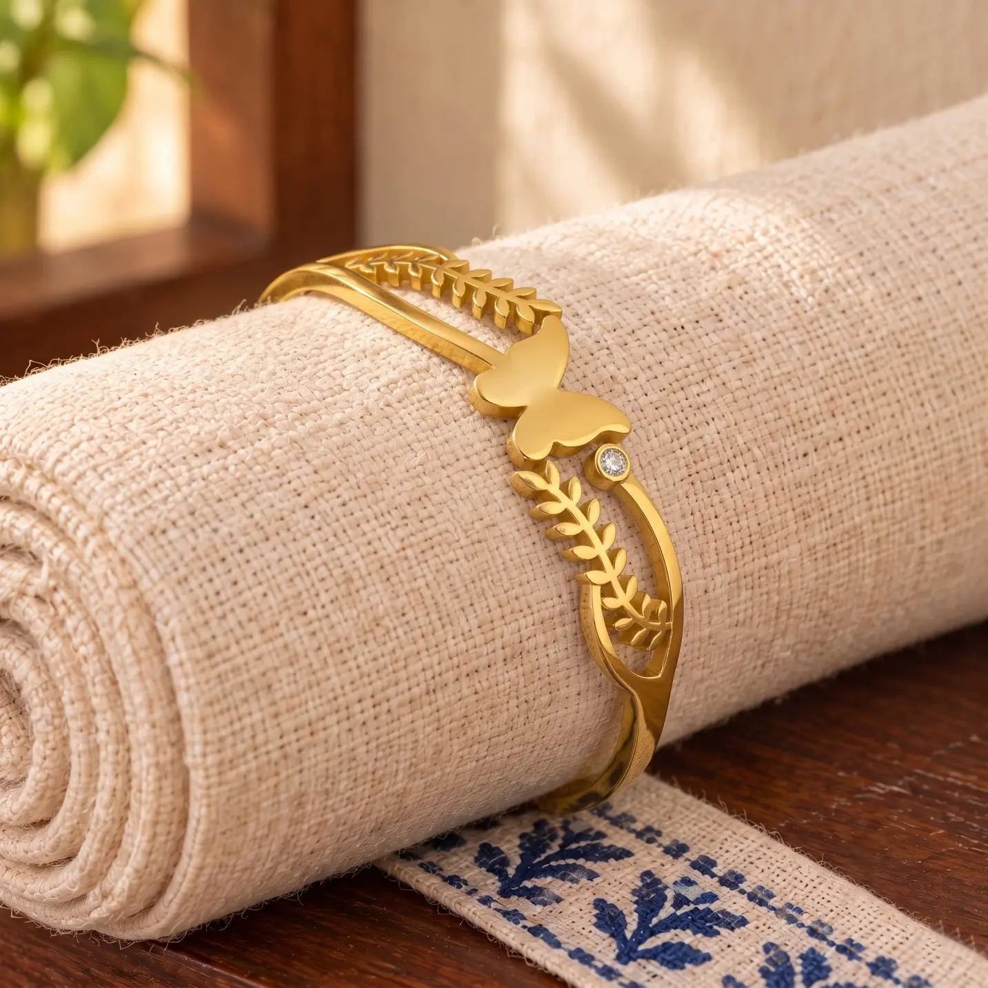 Golden Butterfly Leaf Cuff Bracelet - Linen Roll Display Golden Butterfly Leaf Cuff Bracelet displayed around a rolled ivory linen cloth