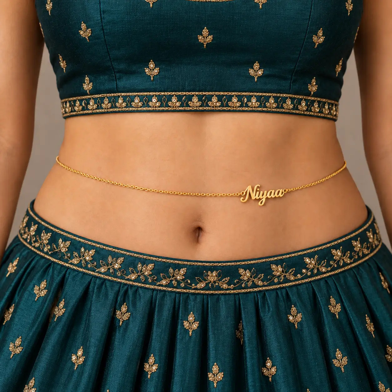Personalized Cursive Name Waist Chain - Traditional Look Gold-tone personalized Niyaa name waist chain worn with a teal embroidered lehenga