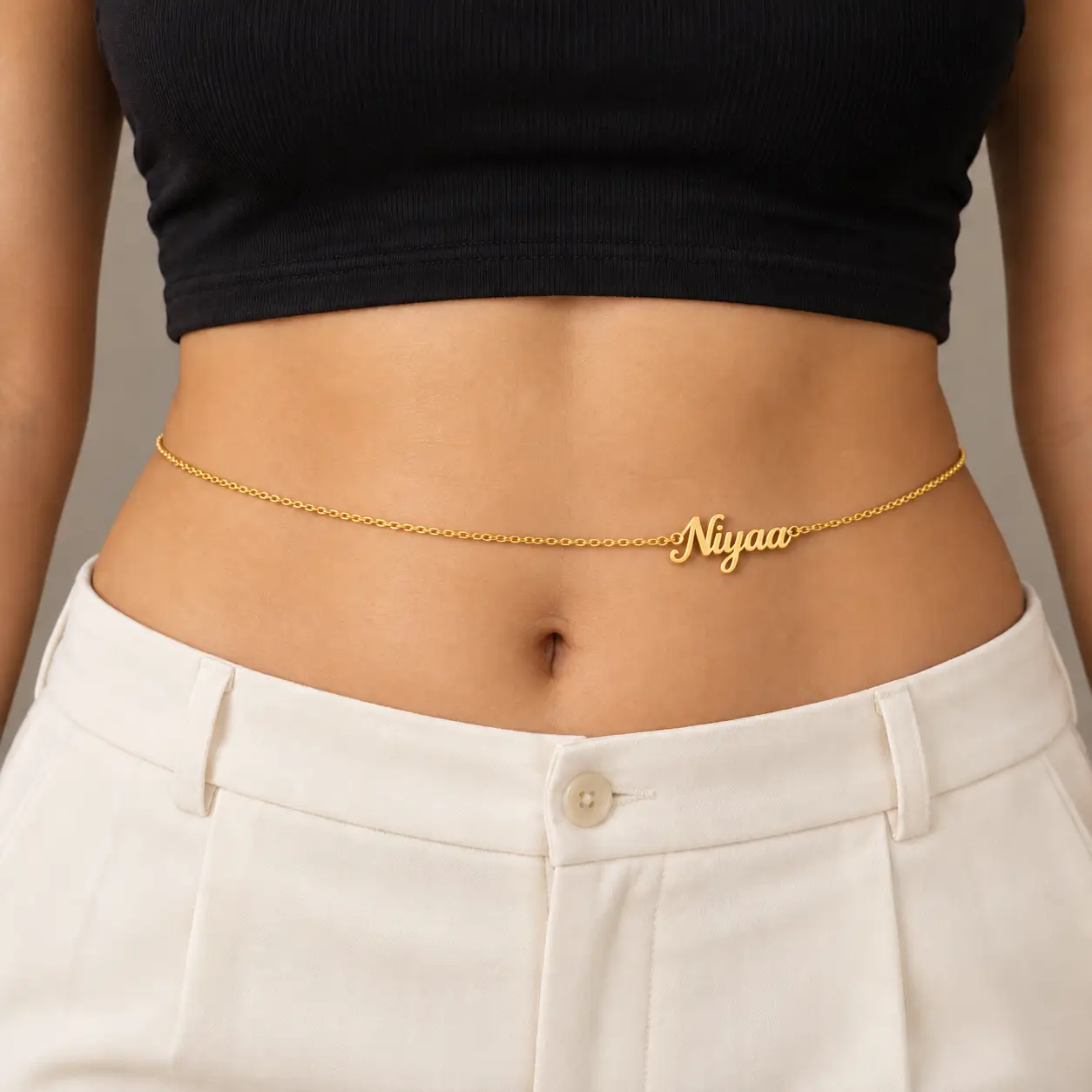 Personalized Cursive Name Waist Chain - Casual Look Gold-tone personalized Niyaa waist chain worn with a black top and ivory trousers